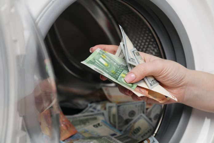 Woman,Putting,Euro,Banknotes,Into,Washing,Machine,,Closeup