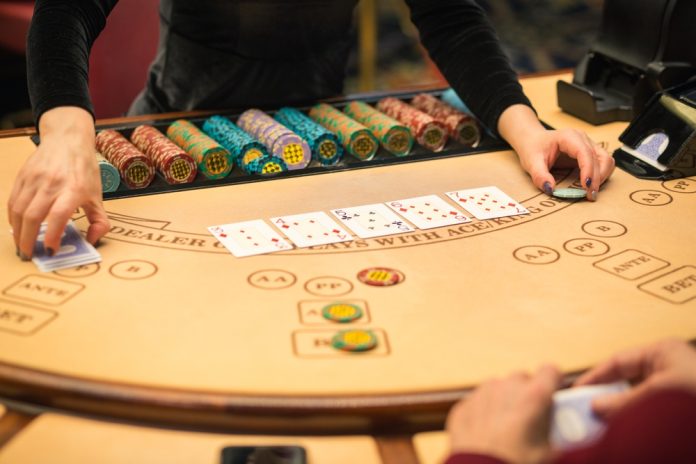 Blackjack,Dealer,Handing,Cards,-,Casino,Table,Game,In,Action
